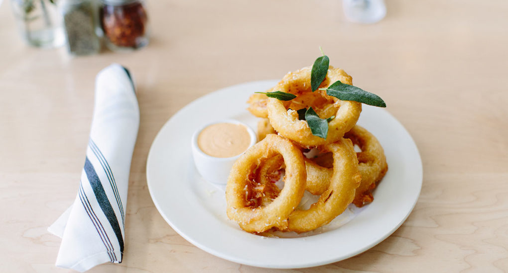 Onion rings with sauce on the table
